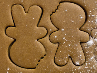close-up shot of gingerbread man shape on dough.