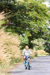Obraz premium Boy riding bicycle on the road.