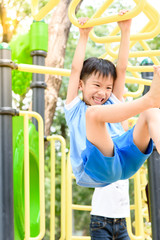 Fototapeta premium Boy play with hang yellow bar.