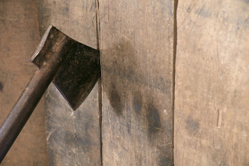 Axe / Old and dirty axe on wood wall.