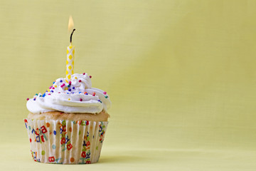 lighted candle on a cupcake