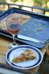 Slice of peach cake and glass of red wine outdoor. Selective focus.
