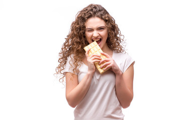 Curly girl eating white chocolate on white background