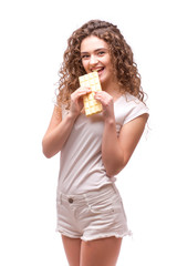 Curly girl eating white chocolate on white background