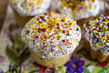 Traditional rustic style Orthodox sweet Easter bread (aka Paskha) topped with sugar glaze on a wooden board