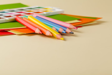 Various school and art supplies laid on table © Andrey Cherkasov
