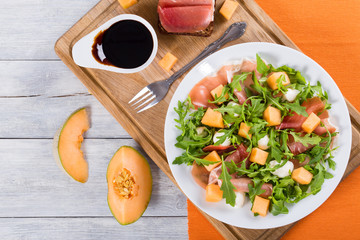 Arugula, prosciutto, mozzarella and melon  salad , top view