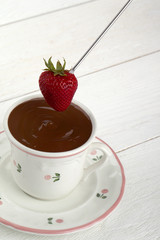 strawberry dip in a cup of chocolate