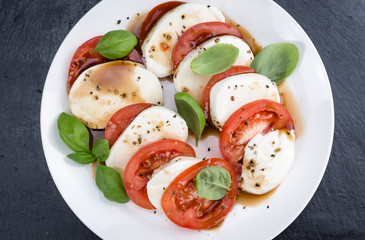 Portion of Mozarella with Tomatoes and Balsamico dressing
