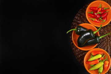Mexican hot chili peppers colorful mix jalapeno on orange bowls