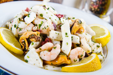 Seafood Salad with prawns, mussels, squids, octopus decorated wi