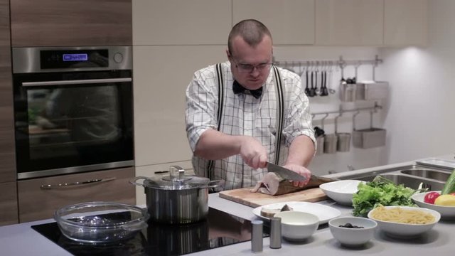 The man cut the fish into steaks