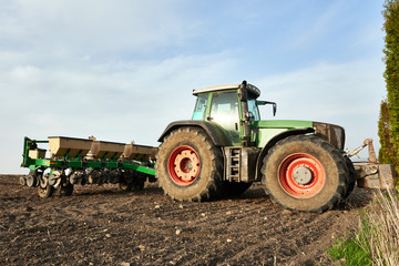 Farmers tractor working on field