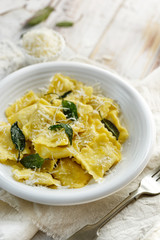 Ravioli with sage butter sprinkled with grana padano cheese