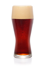 Glass of dark beer on white