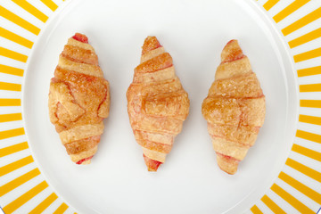 a plate of ham and cheese croissants