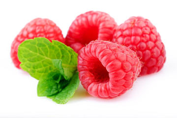 Raspberries with fresh mint leaf on white