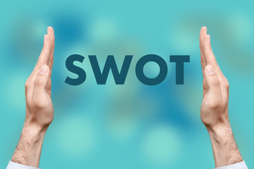 Businessmen from both hands " SWOT " writes