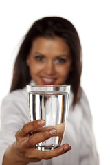 Smiling woman doctor holding a glass of water