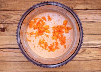 Dough for carrot cake on a wooden table
