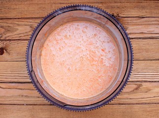 Dough for carrot cake on a wooden table