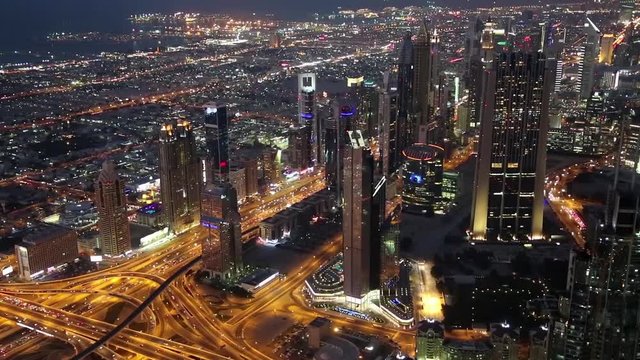 Dubai downtown at night, United Arab Emirates. View on Sheikh Zayed road from 124th floor of Burj Khalifa skyscraper in Dubai, currently the tallest structure in the world. At the top - Burj Khalifa