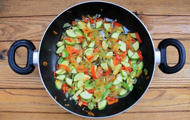 Vegetables stewed fried in oil in a frying pan