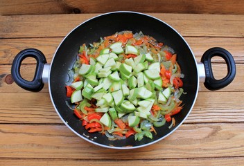 Vegetables stewed fried in oil in a frying pan