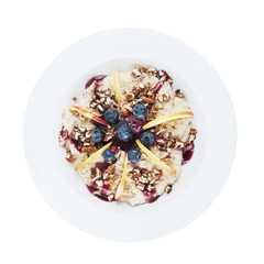 Oatmeal with apples, black berries, nuts and topping