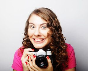 Fototapeta premium young pretty woman holding vintage camera