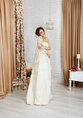 Fototapeta premium Beautiful young bride in crochet shawl and dress