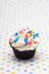 close-up shot of a cupcake with colorful sprinkles.