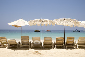 Chairs and umbrella on a beautiful tropical beach Vacation and Tourism concept.Thailand Sea