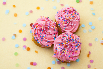 close-up shot of strawberry cupcakes with sprinkles.