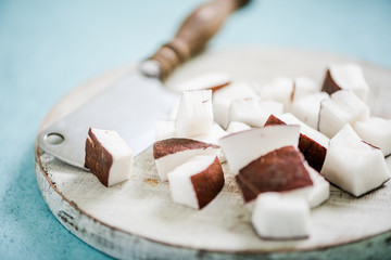Coconut pieces chopped on board