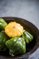 Baby pattypan in rustic bowl