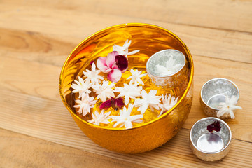 Water with jasmine and roses corolla in bowl for Songkran festival in Thailand.