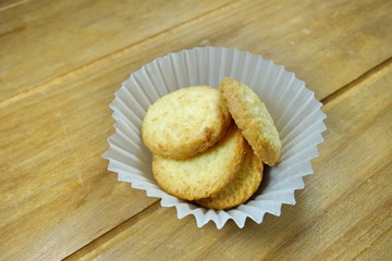 Butter cookies on a wood background.