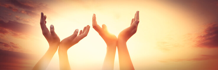 four hands on sunset