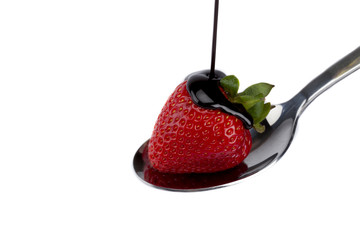 a spoon with chocolate strawberry