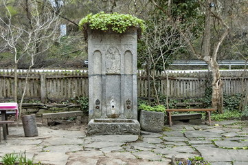 Interesting sculpture on wall of old fountain in the Etar, Gabrovo, Bulgaria 