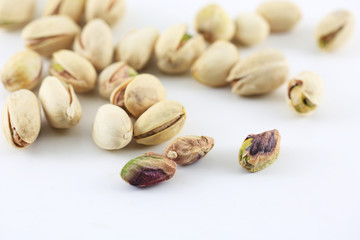 Pistachois nuts on white background.