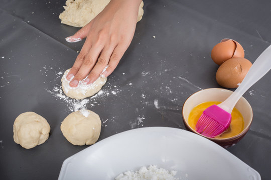 Female hands baking dough