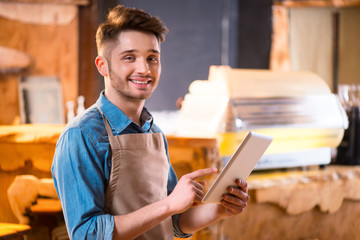 Pleasant waiter  working in the cafe