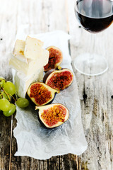 Grape, cheese and figs with a glass of red wine
