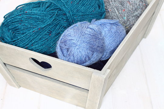Wool wooden crate / Balls of wool in a wooden crate
