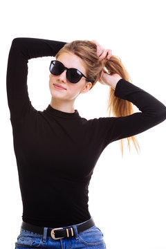 Cute blonde keeps the sunglasses in the Studio on a white backgr