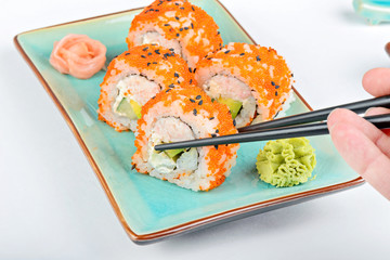Sushi roll with black chopsticks 