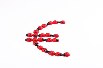 Euro sign with wooden ladybug