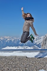 Fototapeta na wymiar Beautiful girl in the high Swiss mountains. Holidays in the mountains. Welcome to Switzerland. The joy of youth. 